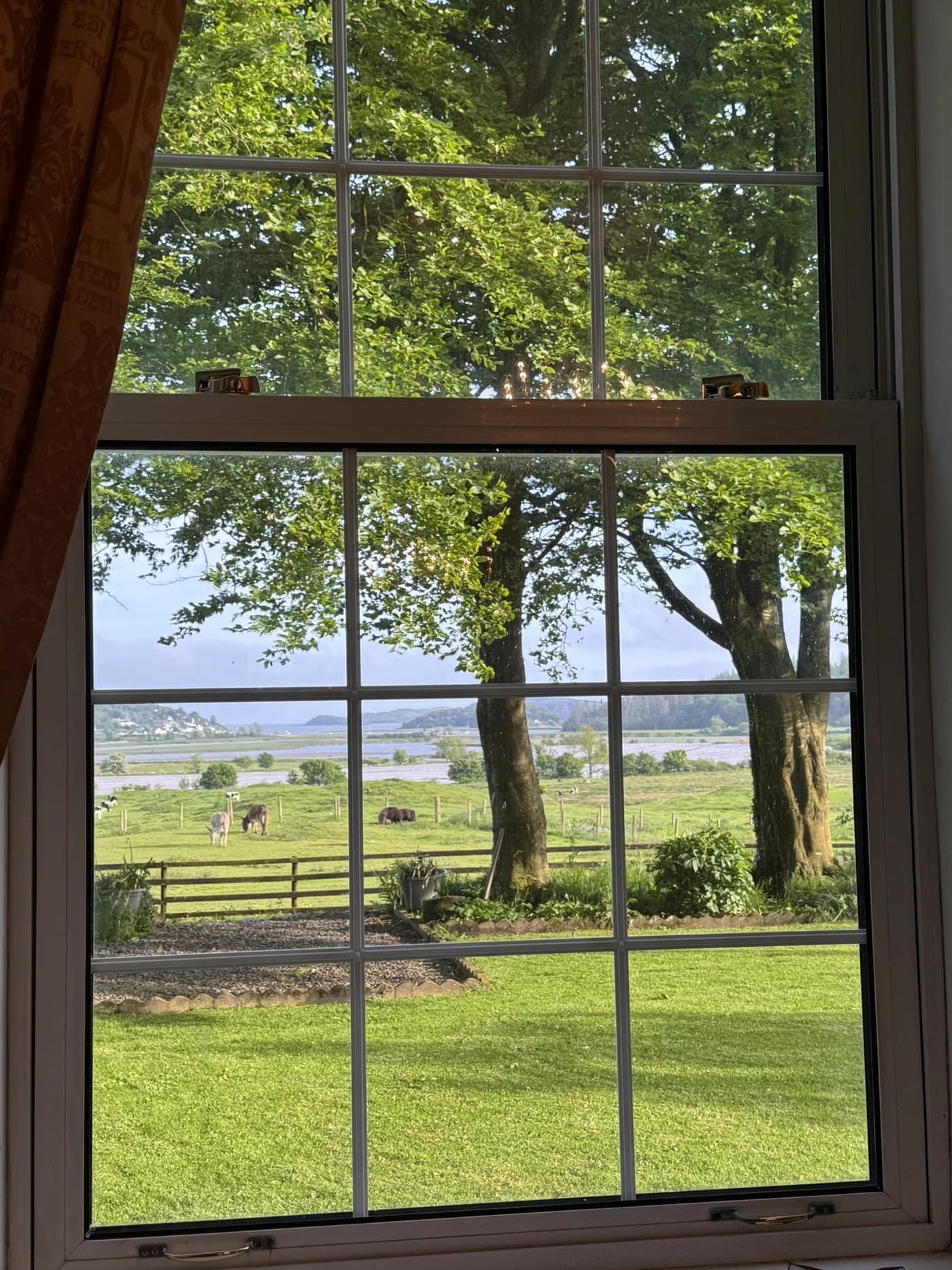 Sash window view over lawn, paddock and the Urr Estuary at Meikle Richorn