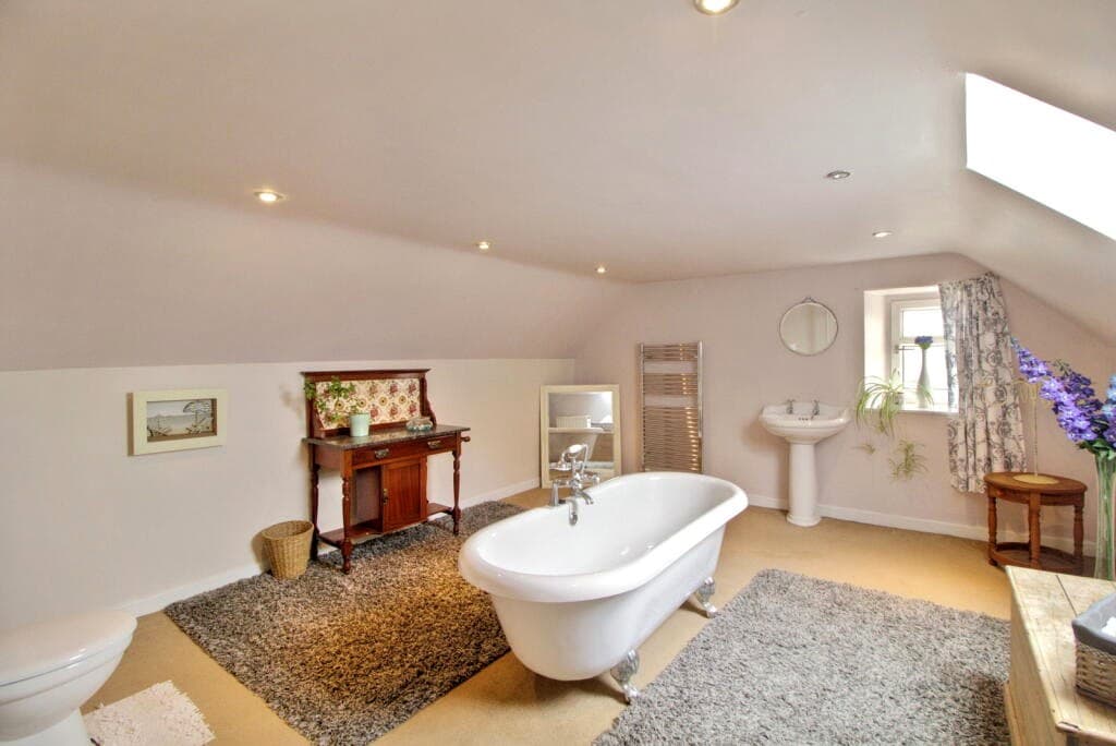 Bathroom with freestanding bath and roof light