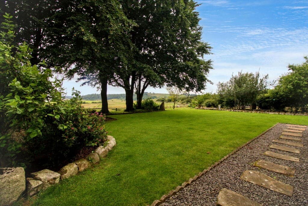Garden lawn at Meikle Richorn looking towards trees and estuary light