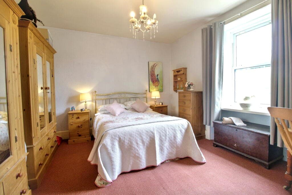 Principal bedroom with sash window and estuary-facing light